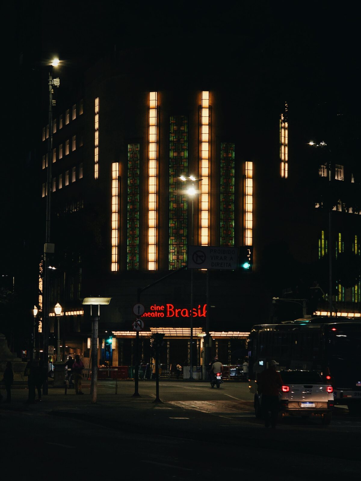 Art deco facade of the Cine Theatro Brasil illuminated at night