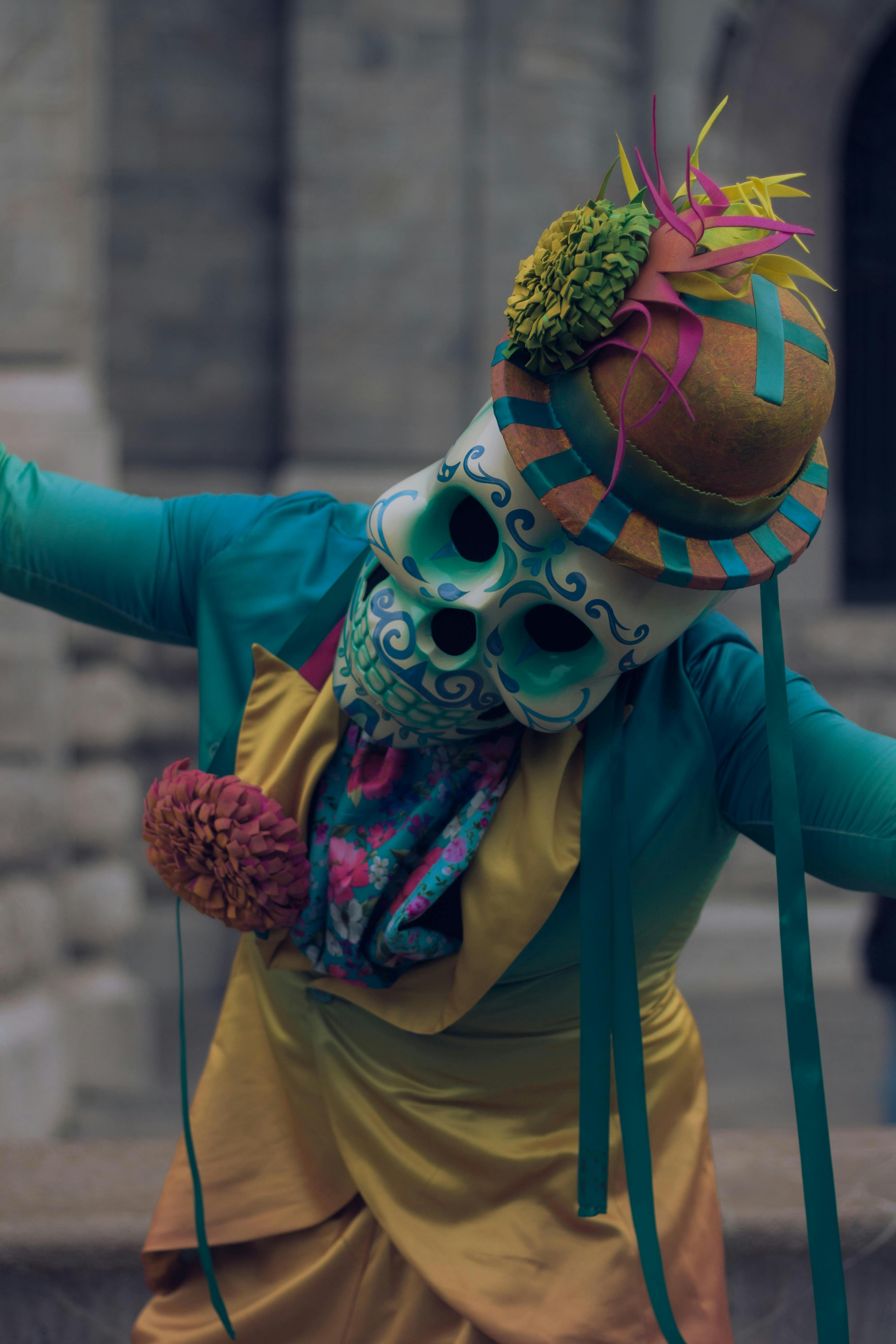 Oaxaca, comparsa with turquoise catrín mask and colourful costume