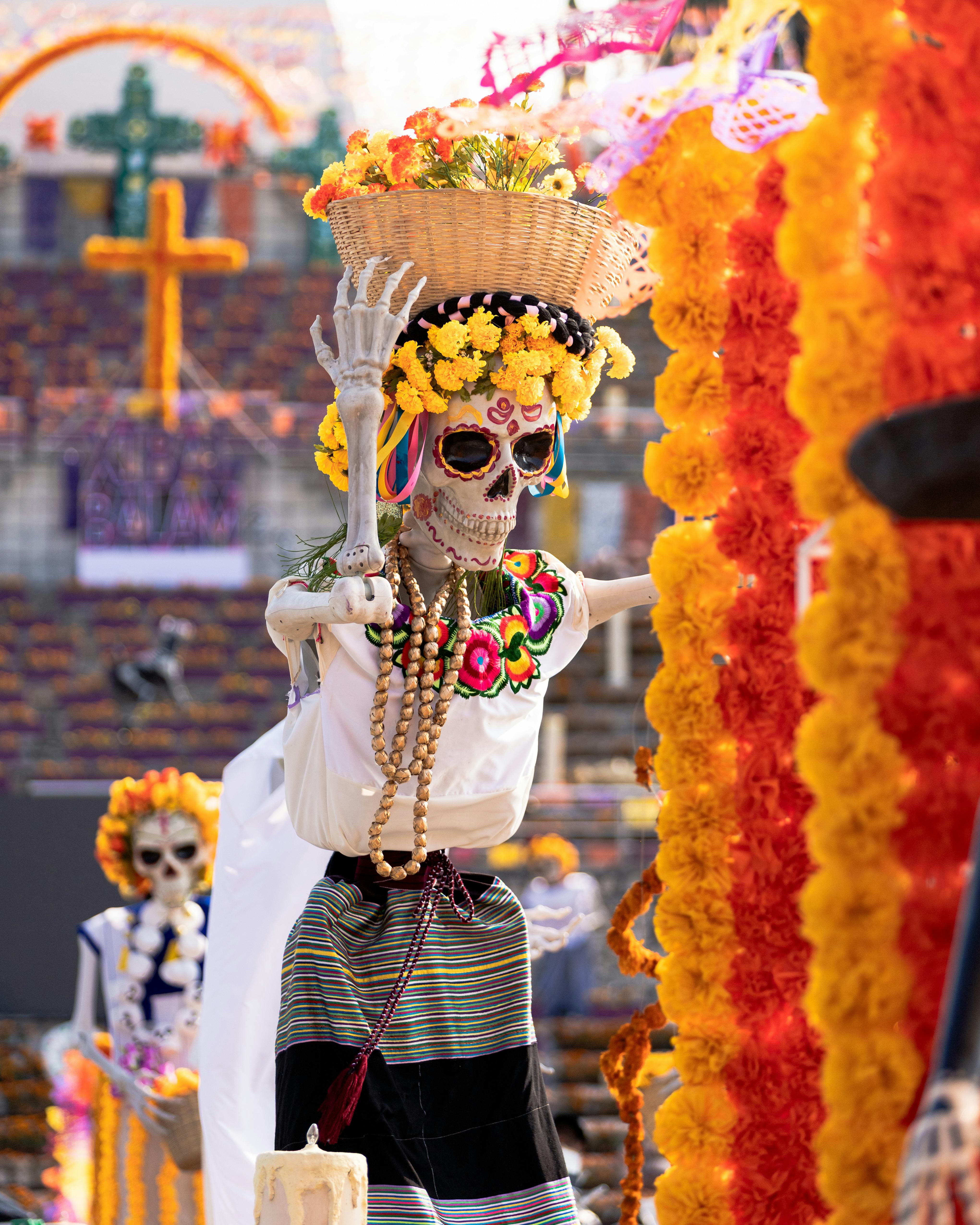 Oaxaca, traditional Catrina with basket of cempasúchil at the parade