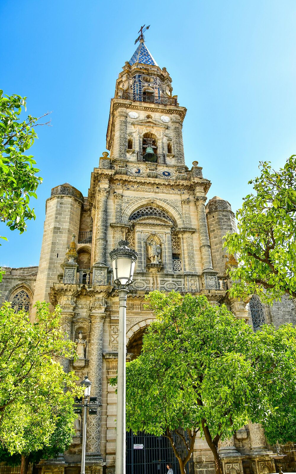 Church tower among trees in Andalusia