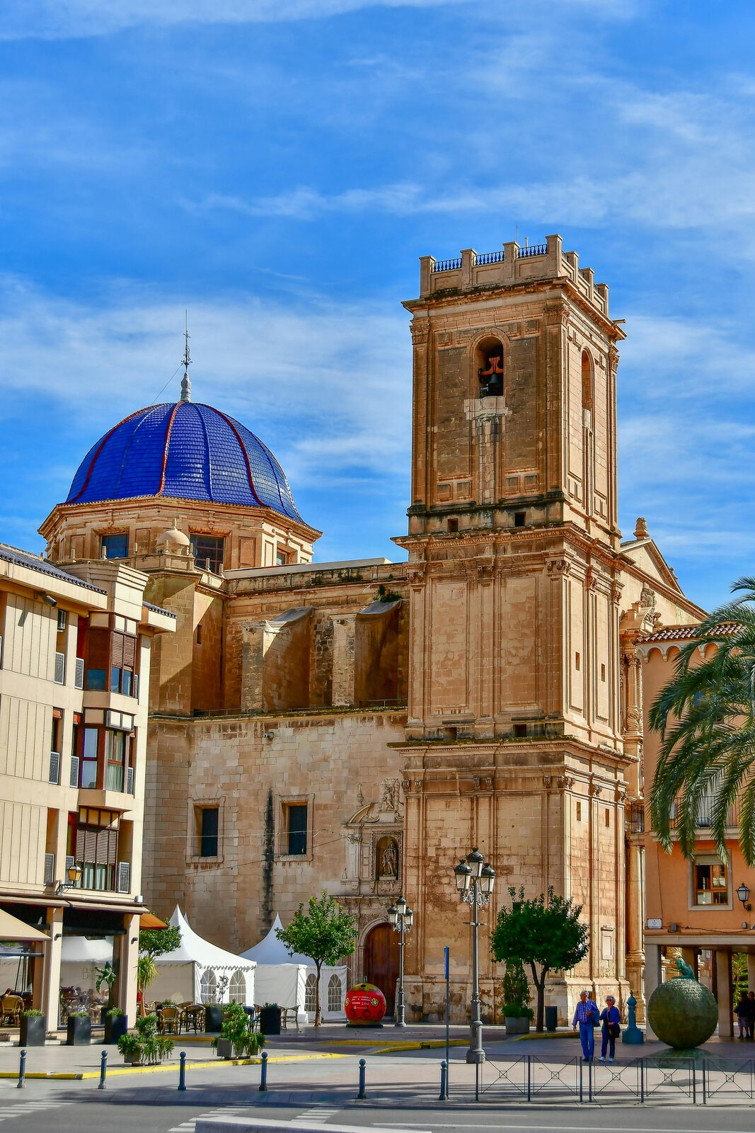 Blue-tiled basilica dome and palm trees in the Spanish Levante