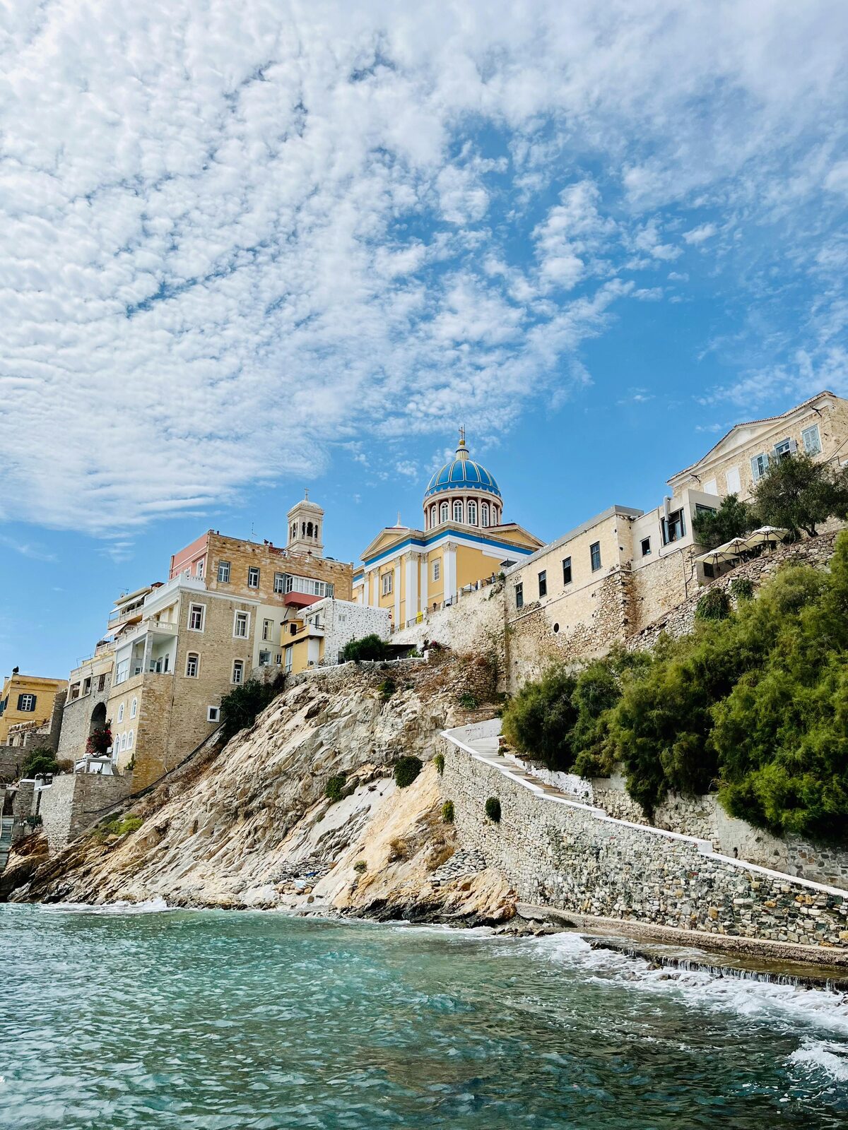 Whitewashed Cycladic village on the edge of the Aegean Sea