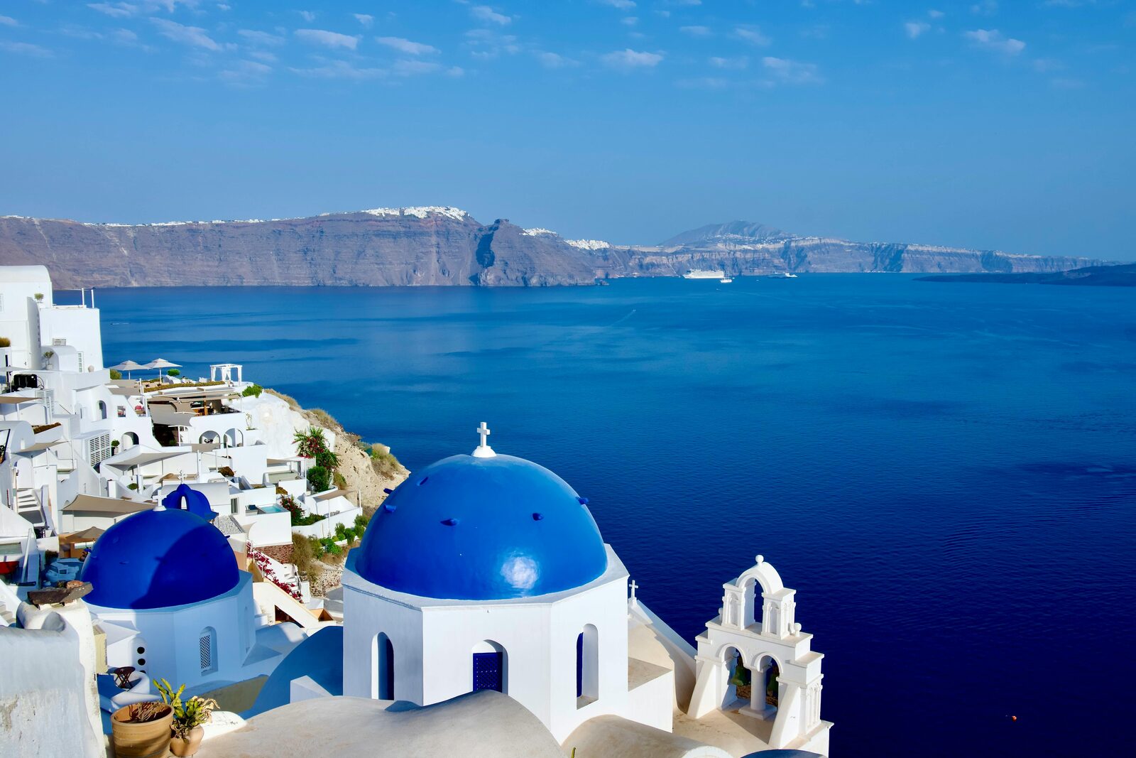 Orthodox blue dome of Oia above the Santorini caldera