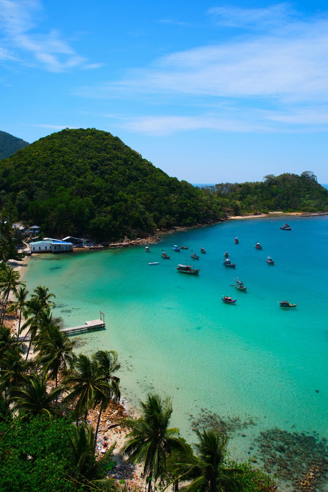 Sandy beach with a longtail boat and turquoise sea